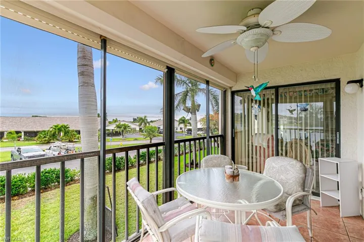 Sunroom / solarium with tile patterned flooring, a residential view, and a textured wall