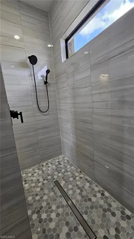 Full bathroom with tiled shower