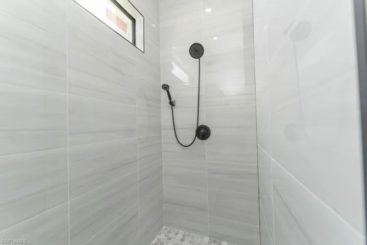Full bath featuring a tile shower