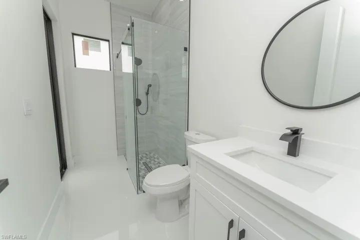 Bathroom featuring vanity, a shower stall, and tile patterned floors