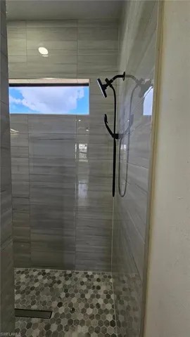 Full bath featuring a tile shower