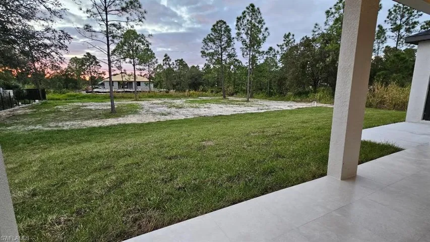 Yard at dusk featuring a yard