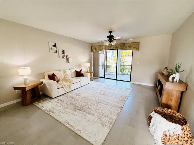 Living room with light wood-style floors and ceiling fan