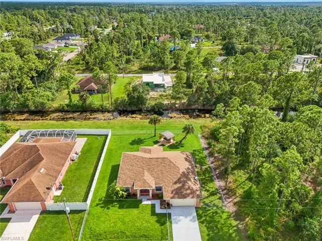 Aerial view of residential area with a heavily wooded area