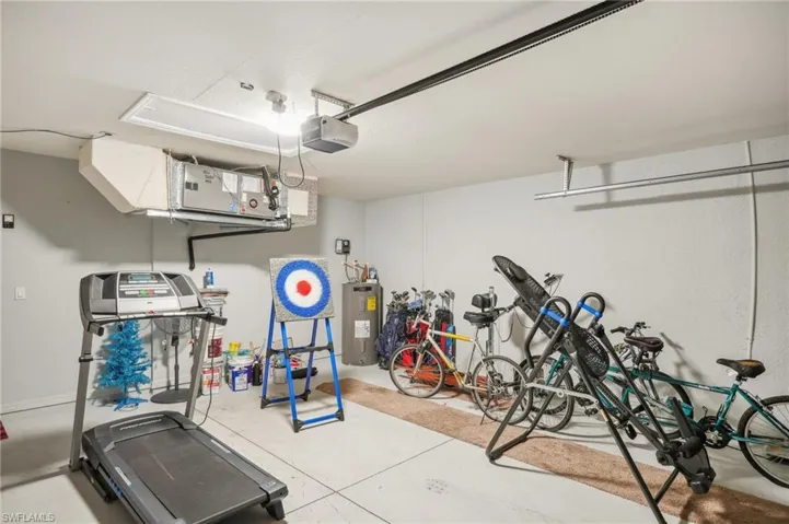 Garage with electric water heater and a garage door opener