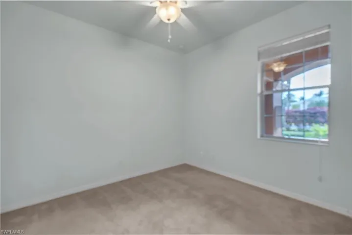 Unfurnished room with carpet flooring and a ceiling fan