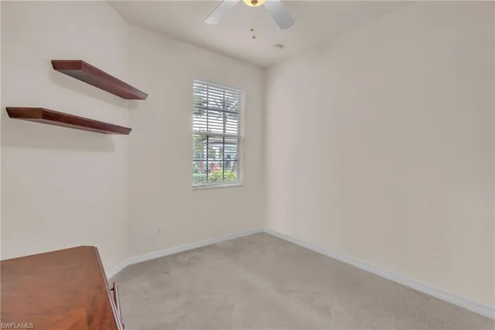 Unfurnished bedroom featuring a ceiling fan and light colored carpet