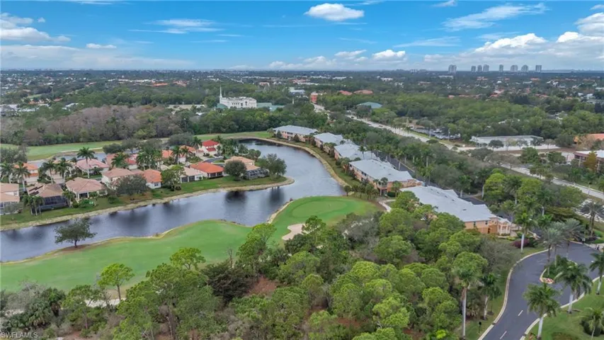 View of property location featuring a golf club and nearby suburban area