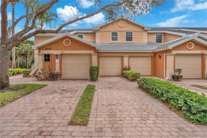 View of front of house featuring stucco siding, decorative driveway, an attached garage, and a tile roof