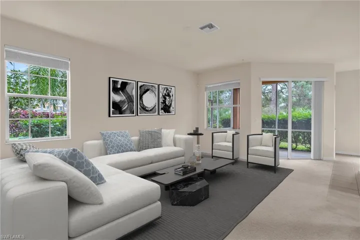 Carpeted living area featuring healthy amount of natural light
