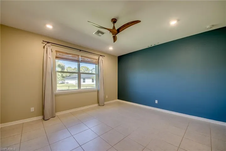 Primary Bedroom featuring a ceiling fan, recessed lighting, and light tile patterned floors