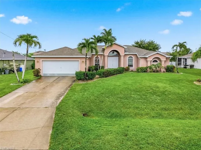 Expansive front lawn with mature palm trees