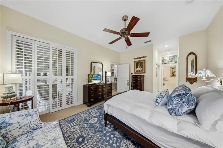 Bedroom featuring access to outside, light carpet, and a ceiling fan