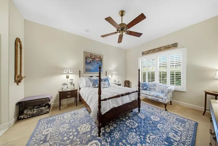 Carpeted bedroom with baseboards and ceiling fan