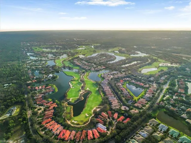Aerial overview of property's location with a large body of water and a local golf course