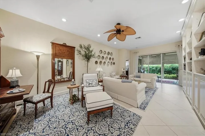 Living room featuring light tile patterned floors, a ceiling fan, and recessed lighting