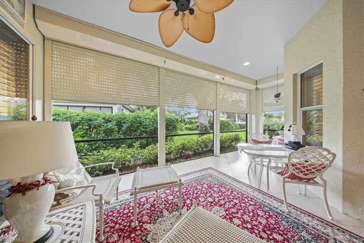 Sunroom / solarium featuring a textured wall, recessed lighting, and tile patterned flooring