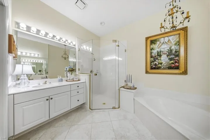 Full bathroom with vanity, a garden tub, a stall shower, and light tile patterned flooring