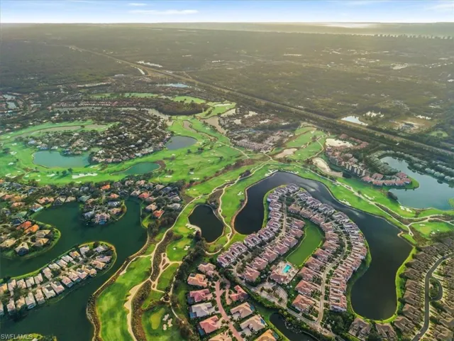 Aerial overview of property's location featuring a large body of water and a local golf course