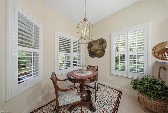 Dining room with a chandelier and tile patterned flooring