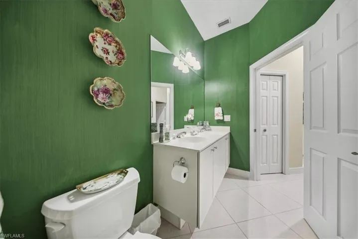 Full bathroom with double vanity and light tile patterned floors