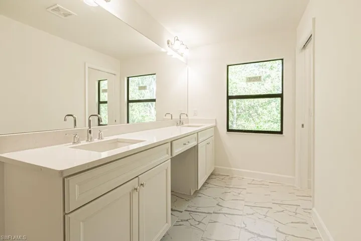 Bathroom with vanity and plenty of natural light