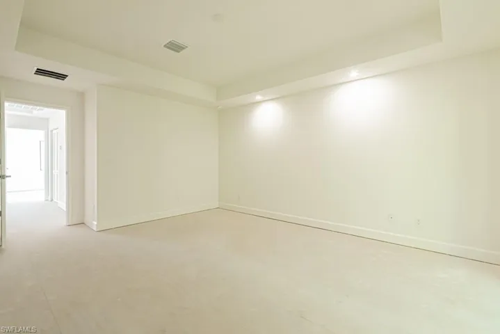 Empty room featuring a tray ceiling