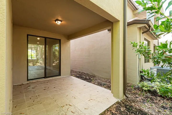 Doorway to property with a patio area