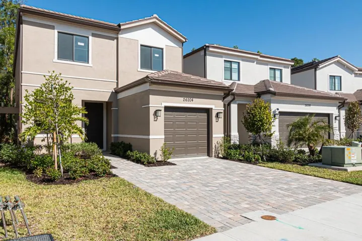 View of front of property with central AC and a garage