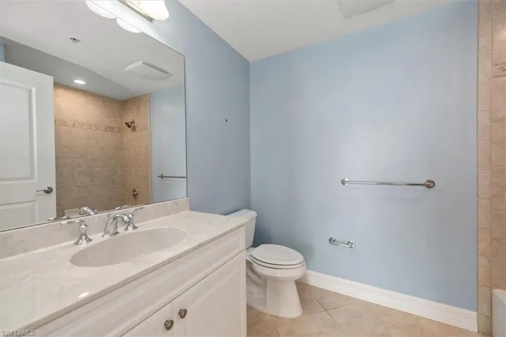 Full 2nd bathroom with light tile patterned floors, vanity, and tiled shower