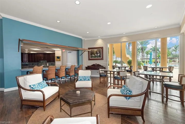 Living area featuring ornamental molding, recessed lighting, and dark wood finished floors