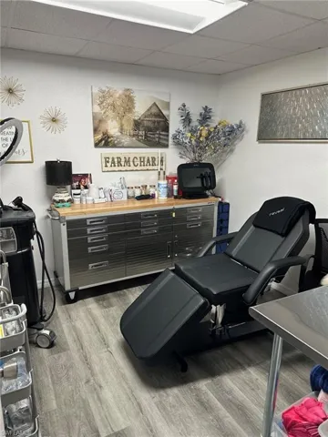 Miscellaneous room with a drop ceiling and wood finished floors