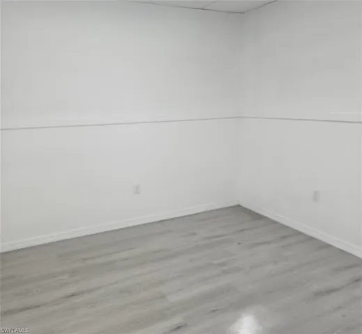 Unfurnished room with baseboards and wood finished floors