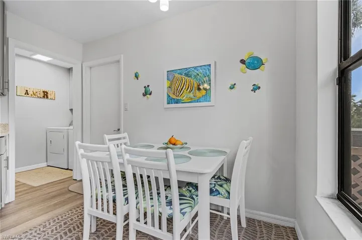 Dining area featuring light wood-type flooring and washing machine and clothes dryer