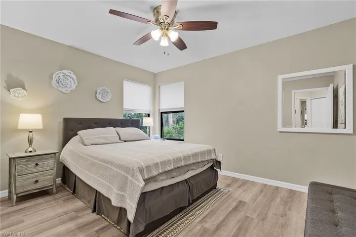 Bedroom with ceiling fan and light hardwood / wood-style flooring