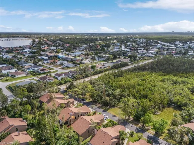 Birds eye view of property with a water view