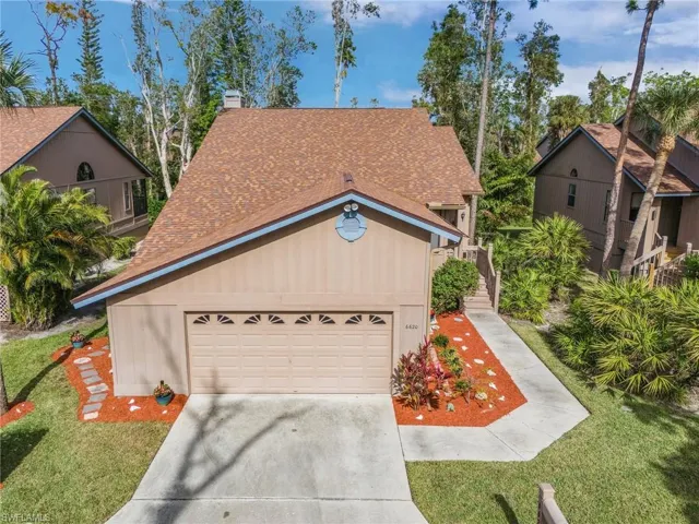 View of front of home featuring a garage and a front yard
