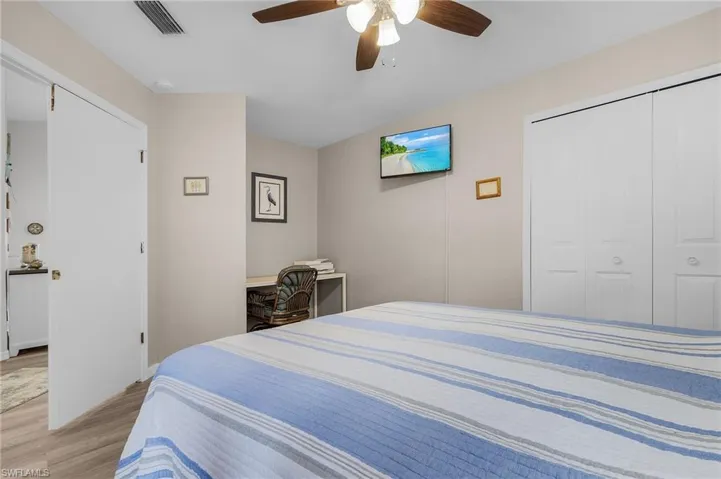 Bedroom with ceiling fan, a closet, and light hardwood / wood-style floors