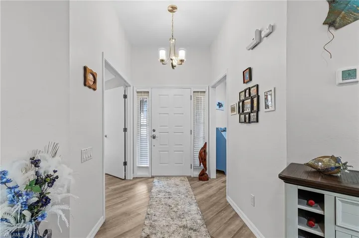 Foyer featuring light hardwood / wood-style flooring and a notable chandelier