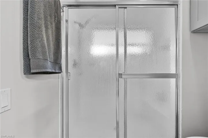 Bathroom with a shower with shower door