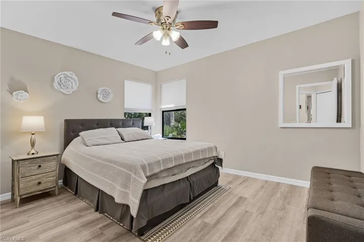 Bedroom with light hardwood / wood-style floors and ceiling fan