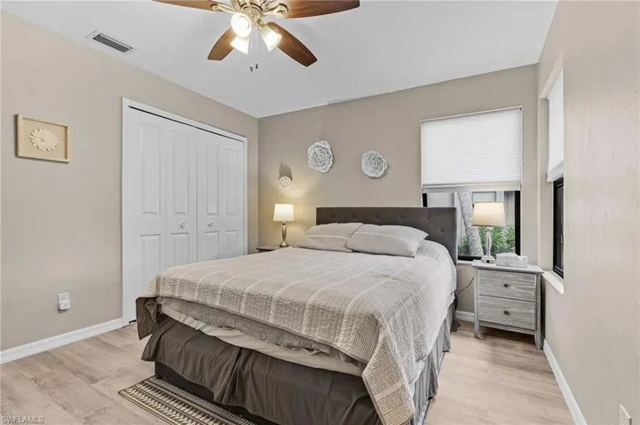 Bedroom featuring a closet, light hardwood / wood-style flooring, and ceiling fan