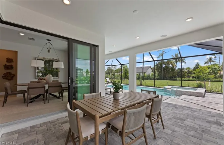 View of patio / terrace featuring outdoor dining space, and a pool with connected hot tub