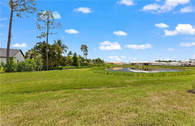 View of grassy yard with a water view
