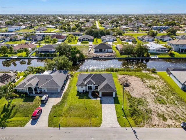 Aerial view of residential area featuring a large body of water