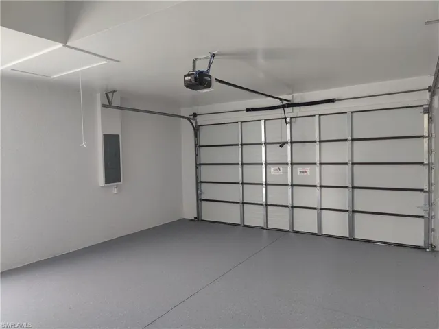 Garage with a garage door opener and electric panel