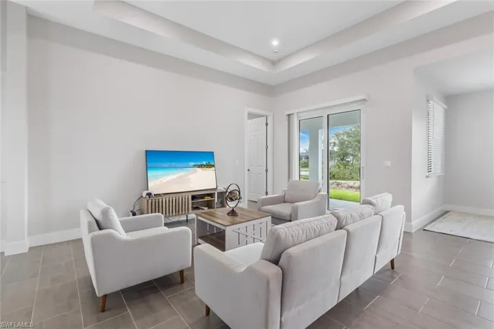 Living area with a raised ceiling and recessed lighting