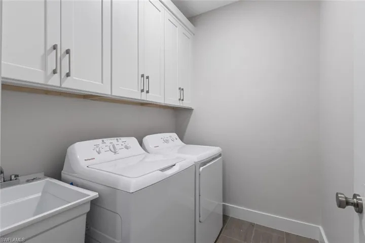 Laundry room featuring cabinet space and independent washer and dryer