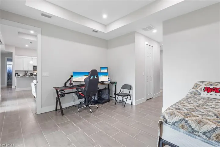 Bedroom with a desk and recessed lighting