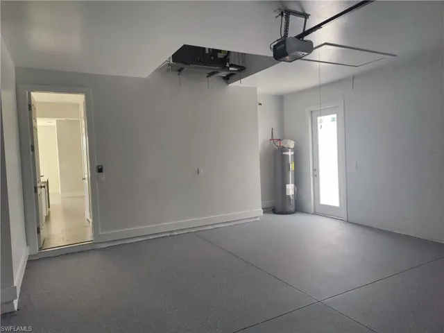 Garage with electric water heater and a garage door opener